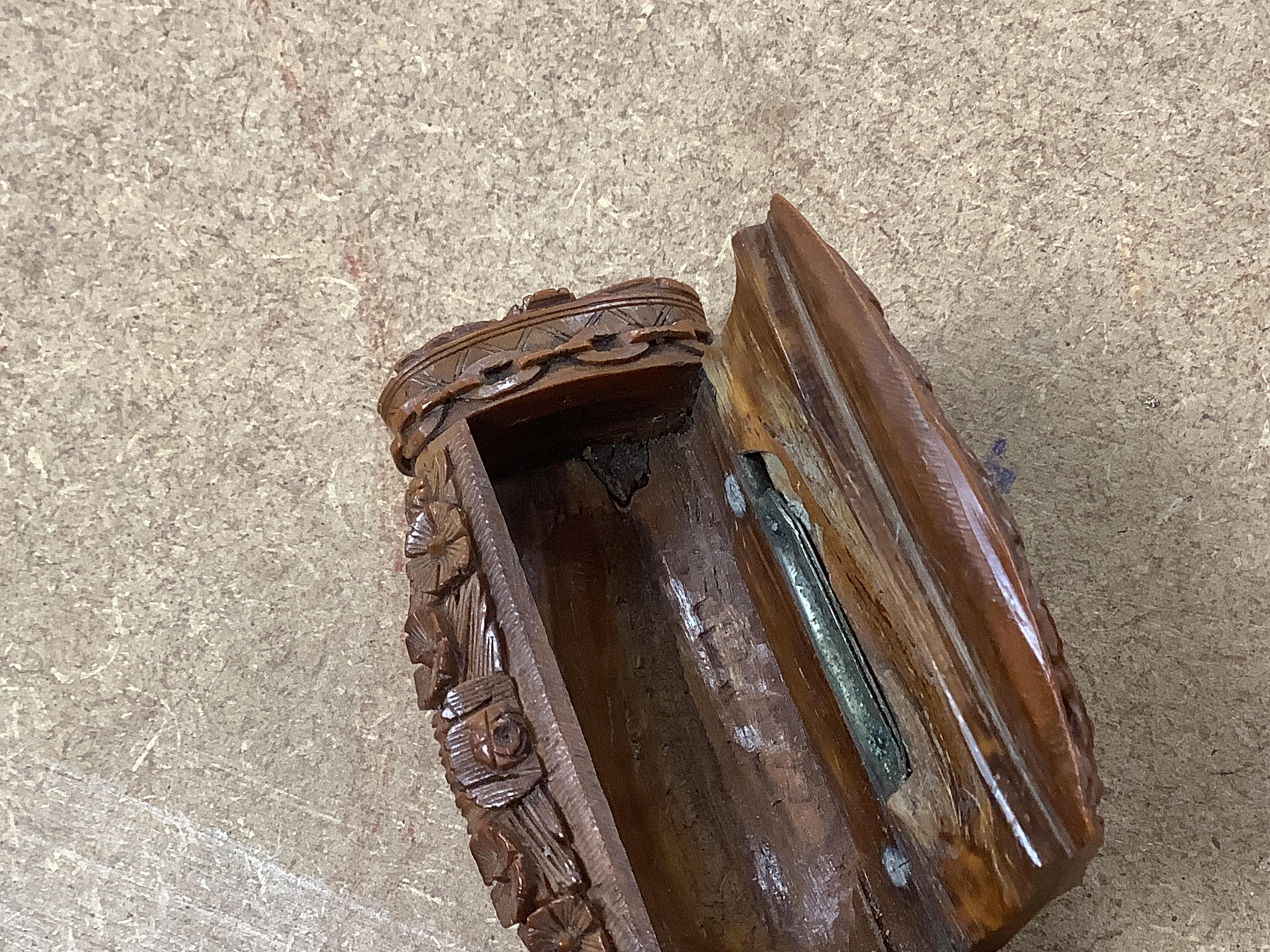 An 18th / 19th century European carved figural coquilla nut snuff box, 8.5cm wide